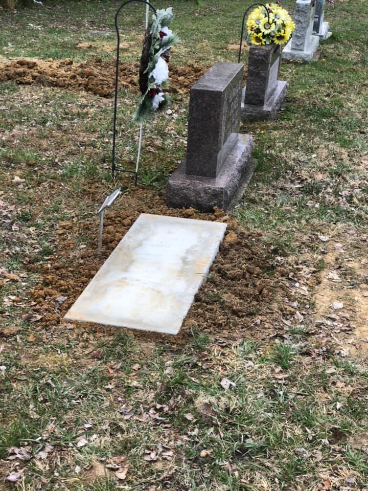 Historic upright headstone in Bells Corners Cemetery with mature trees in the background